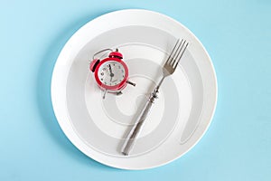 Diet. Eating control or time to diet concept , alarm clock with healthy tool concept decoration on blue background