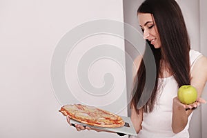 Diet And Fast Food Concept. Overweight Woman Standing On Weighing Scale Holding Pizza. Unhealthy Junk Food. Dieting, Lifestyle. W