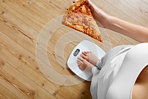 Diet, Fast Food. Woman On Scale Holding Pizza. Obesity.