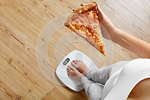 Diet, Fast Food. Woman On Scale Holding Pizza. Obesity.