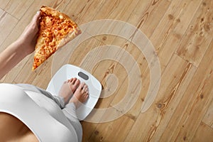 Diet, Fast Food. Woman On Scale Holding Pizza. Obesity.
