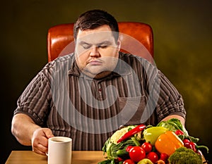 Diet fat man eating healthy food . Healthy slimming tea.