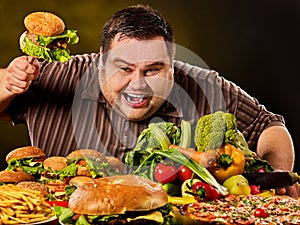 Diet fat man makes choice between healthy and unhealthy food.