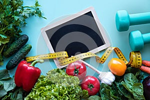 Diet. Fitness and healthy food diet concept. Balanced diet with vegetables on blue background.