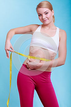 Diet. Fitness woman fit girl with measure tape measuring her waist