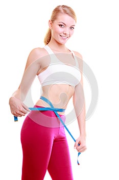 Diet. Fitness woman fit girl with measure tape measuring her waist