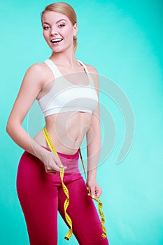 Diet. Fitness woman fit girl with measure tape measuring her waist