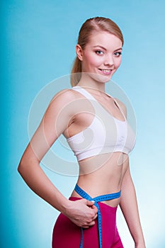 Diet. Fitness woman fit girl with measure tape measuring her waist