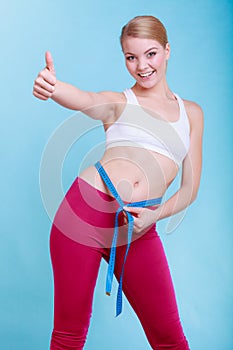 Diet. Fitness woman fit girl with measure tape measuring her waist