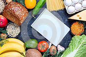 Diet food menu with vegetables and fruits on a black stone background
