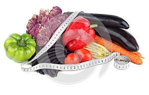 Diet food. Vegetables and measuring tape on a white background.