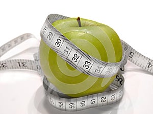 Diet fruit with measure tape (green apple)