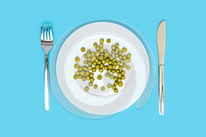 Diet and healthy eating. A white plate with canned peas, a fork and a table knife side by side on a blue background. Top view