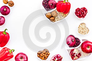 Diet for healthy heart. Food with antioxidants. Vegetables, fruits, nuts in heart shaped bowl on white background top