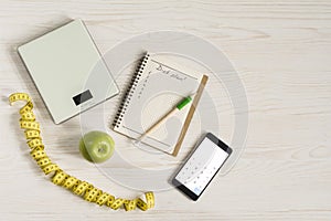 Diet and Healthy life Concept. Apple and Weight scale on white wooden background. top view and copy space