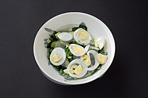 Diet menu. Healthy salad of fresh vegetables - tomatoes  avocado  arugula  egg  spinach and quinoa on a bowl. Flat lay. Top view