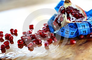 Diet mesaure fruit pomegranate on wood photo