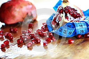 Diet mesaure fruit pomegranate on wood photo