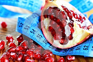 Diet mesaure fruit pomegranate on wood photo