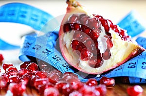 Diet mesaure fruit pomegranate on wood photo