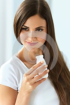 Diet Nutrition. Beautiful Smiling Woman Drinking Yoghurt Indoors