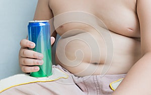 Diet. Obese fat boy holding soft drink can.