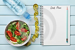 Diet plan, menu or program, tape measure, water and diet food of fresh salad on blue background, weight loss and detox concept