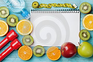 Diet plan, menu or program, tape measure, water, dumbbells and diet food of fresh fruits on blue background, detox concept