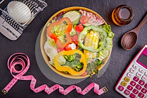 Diet plan, tape measure, calculator for Count calories, salad