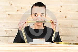 Diet. Portrait woman wants to eat a Burger but stuck skochem mouth, the concept of diet, junk food, willpower in nutrition