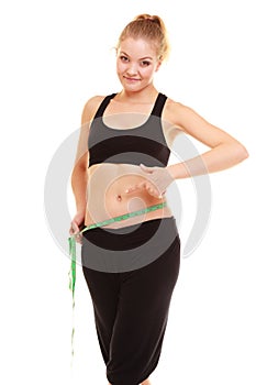 Diet. slim blonde girl with measure tape measuring waist
