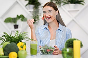 Diet and vegetarian concept. Happy woman eating vegetable salad