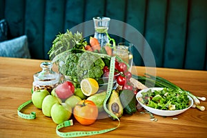 Diet weight loss breakfast concept with tape measure, organic fruits , vegetables, salad and fresh water. Healthy nutrition
