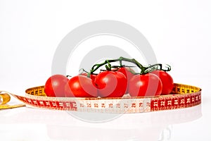 Diet weight loss concept with tape measure organic tomatoes
