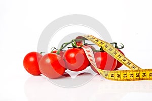 Diet weight loss concept with tape measure organic tomatoes with