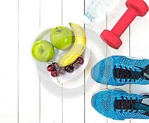 Diet and weight loss for healthy care with fitness equipment,fresh water and fruit healthy,apple green apple, banana,cherry on wh