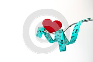 Diet for weight loss , measuring tape with fork with a red heart