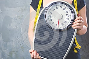 Diet and weight - young woman with a scale