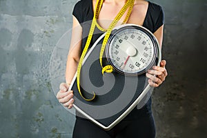 Diet and weight - young woman with a scale