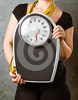 Diet and weight - young woman with a scale