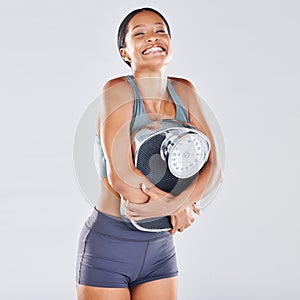 Diet, weightloss and scale with a black woman athlete in studio on a gray background for body positivity or health