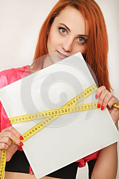 Diet. woman holding weight scale and measuring