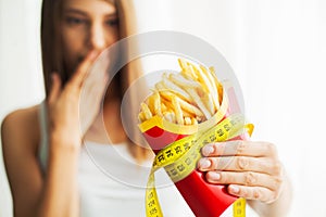 Diet. Woman Measuring Body Weight On Weighing Scale Holding Unhealthy Junk Food. Weight Loss. Obesity. Top View