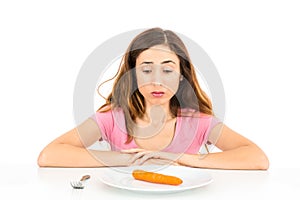 Diet woman with one carrot for dinner