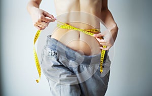 Diet. Woman in Sportswear Measuring Her Waist. Dieting concept