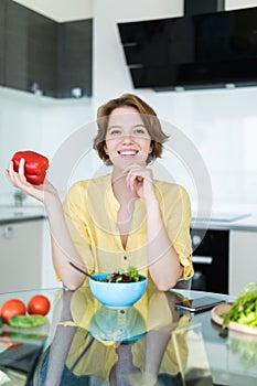 Diet. Young beautiful woman eating vegetable salad holding pepper in hands. Dieting concept. Healthy Food