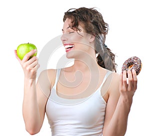 Diet. Young Woman choosing between Fruit and Donut