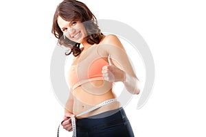 Diet - young woman is measuring her waist