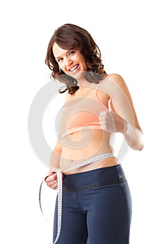 Diet - young woman is measuring her waist