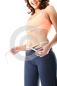 Diet - young woman is measuring her waist